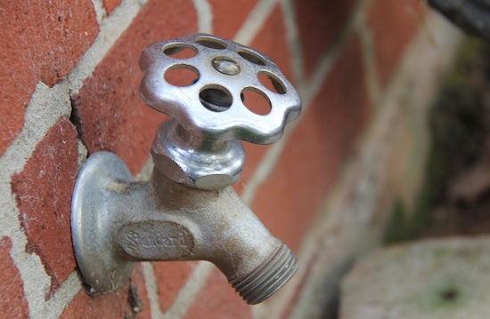 An outdoor water spigot extends from a building on the University of Georgia campus in Griffin, Ga.