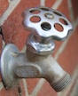 An outdoor water spigot extends from a building on the University of Georgia campus in Griffin, Ga.