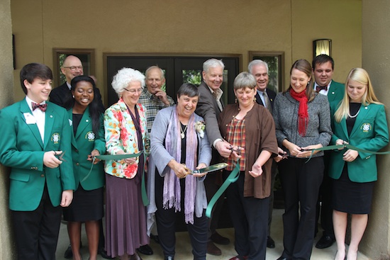 Diane Davies wields a ceremonial pair of scissors to cut the ribbon at Rock Eagle 4-H Center museum that now bears her name. The Diane Davies Natural History Museum honors Davies for creating the Georgia 4-H Environmental Education Program. Pictured left to right during the ribbon cutting are Georgia 4-H State Representative Brett Allen, Georgia 4-H State Represenative Maya Mapp, University of Georgia Cooperative Extension Associate Dean Beverly Sparks, Davies, Sara Thompson, Georgia 4-H Environmental Education Program Director Melanie Biersmith, Georgia 4-H Northeast District Representative Elizabeth Savage, (back row) Georgia 4-H Foundation Board of Trustees Chairman Jay Morgan, Retired Georgia 4-H State Leader Tom Rodgers, UGA College of Agricultural and Environmental Sciences Dean J. Scott Angle, Georgia 4-H State Leader Arch Smith and Georgia 4-H President Oakley Perry.
