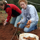 Students learn the meaning of slow gardening (instead of instant gratification) while helping out at a farm in Winterville, Ga.