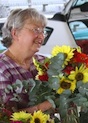 A grower sells fresh cut flowers at a farmers market in Henry County.