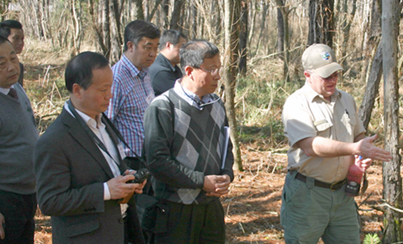 Mark McClure, Forest Health Specialist with the Georgia Forestry Commission, talks with members of a Chinese Delegation during a trip to south Georgia last month.