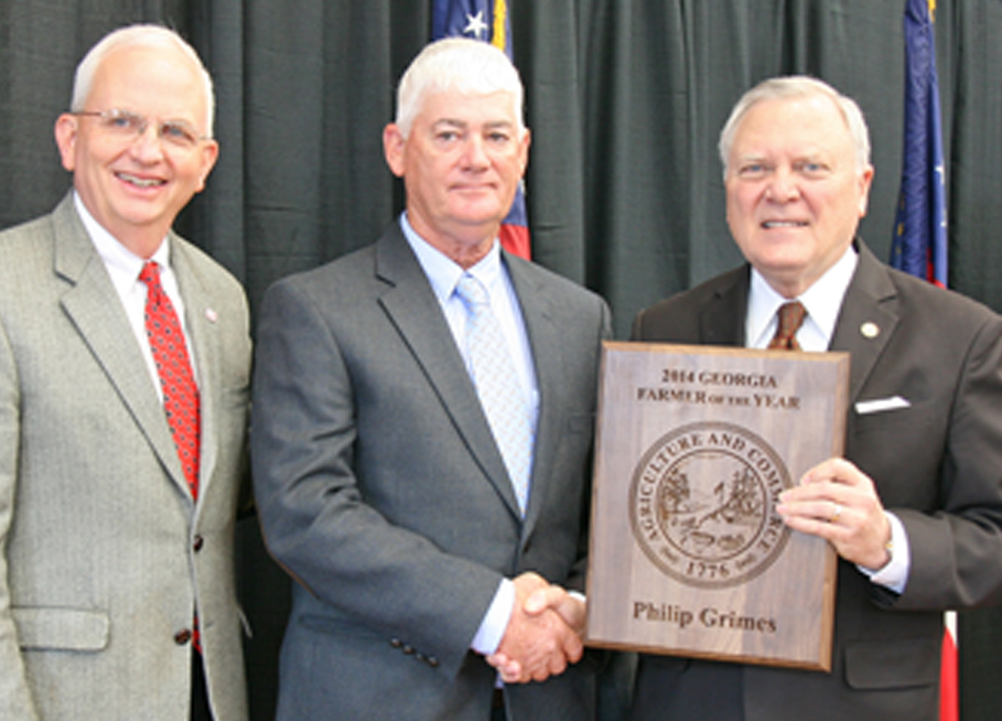 Georgia Farmer of the Year Philip Grimes receives a plaque from Gov. Nathan Deal, on right, and Agriculture Commissioner Gary Black, on left.