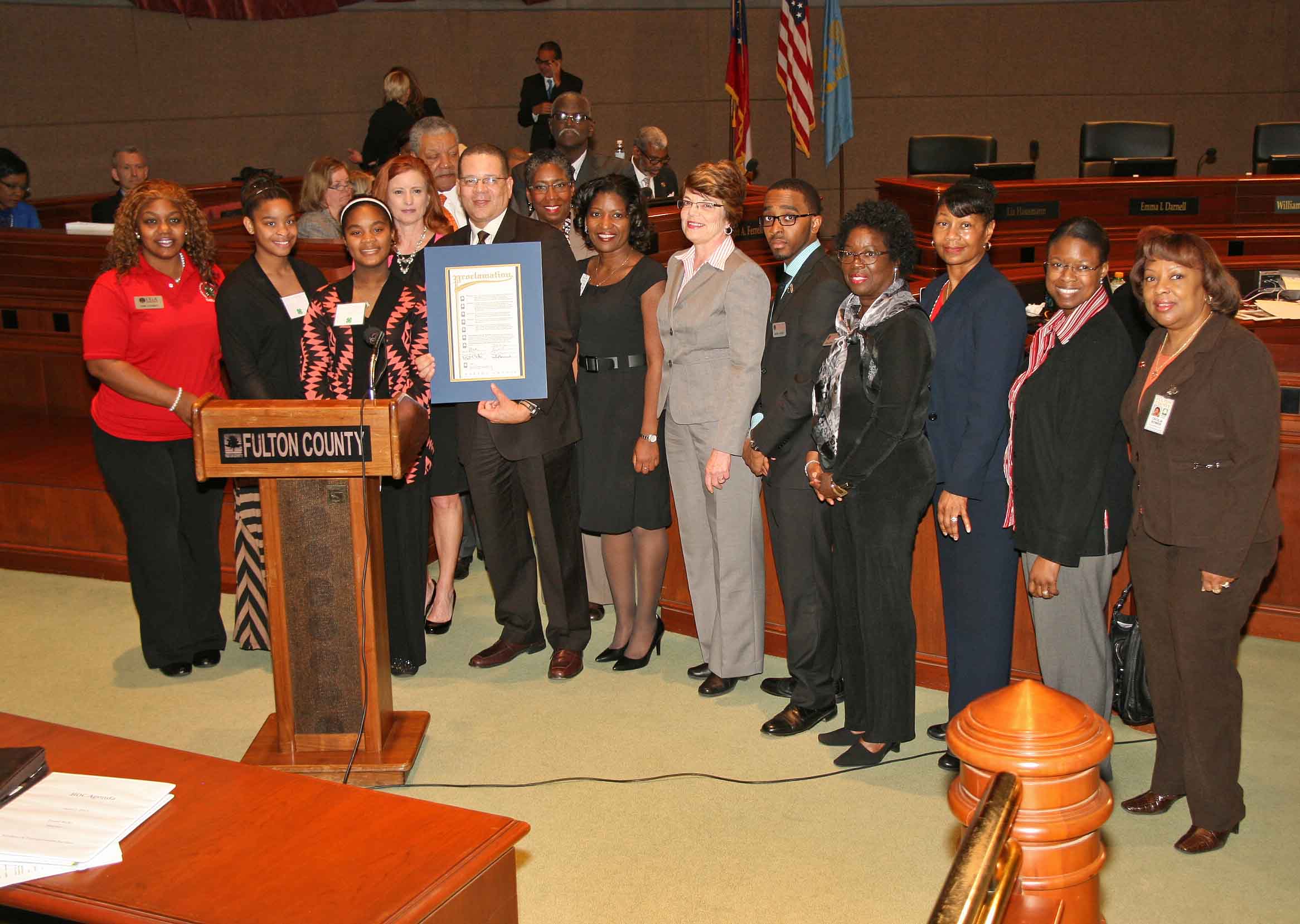 Fulton County Commission Chairman John Eaves presents a proclamation honoring UGA Extension's 100 years of service in Fulton County to County Extension Coordiantor Menia Chester, to his right; UGA Office of Environmental Sciences Director Susan Varlamoff, to her right, and the staff of the Fulton County UGA Extension Office.