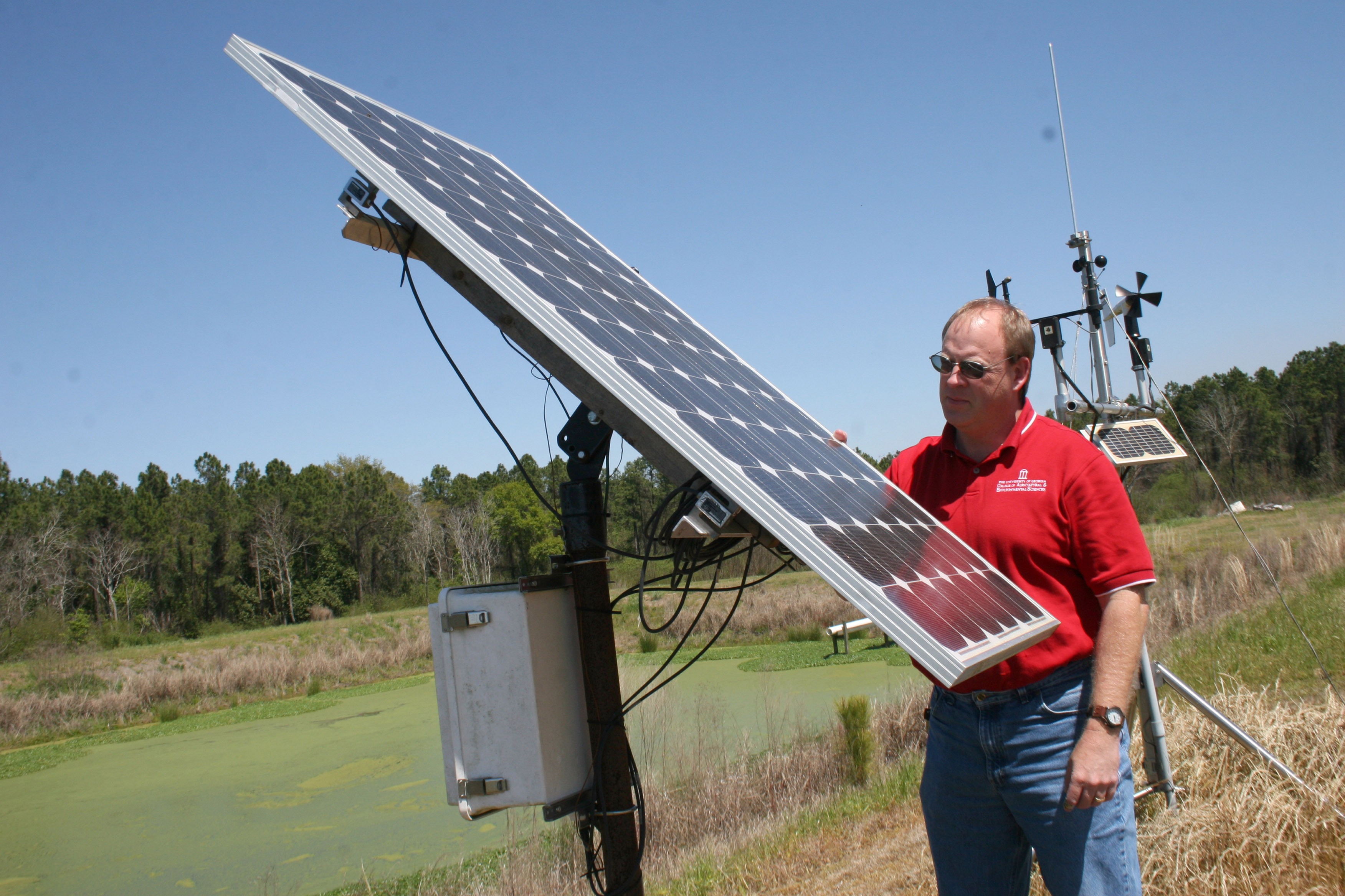 University of Georgia Extension water resource specialist Gary Hawkins looks over a solar panel.