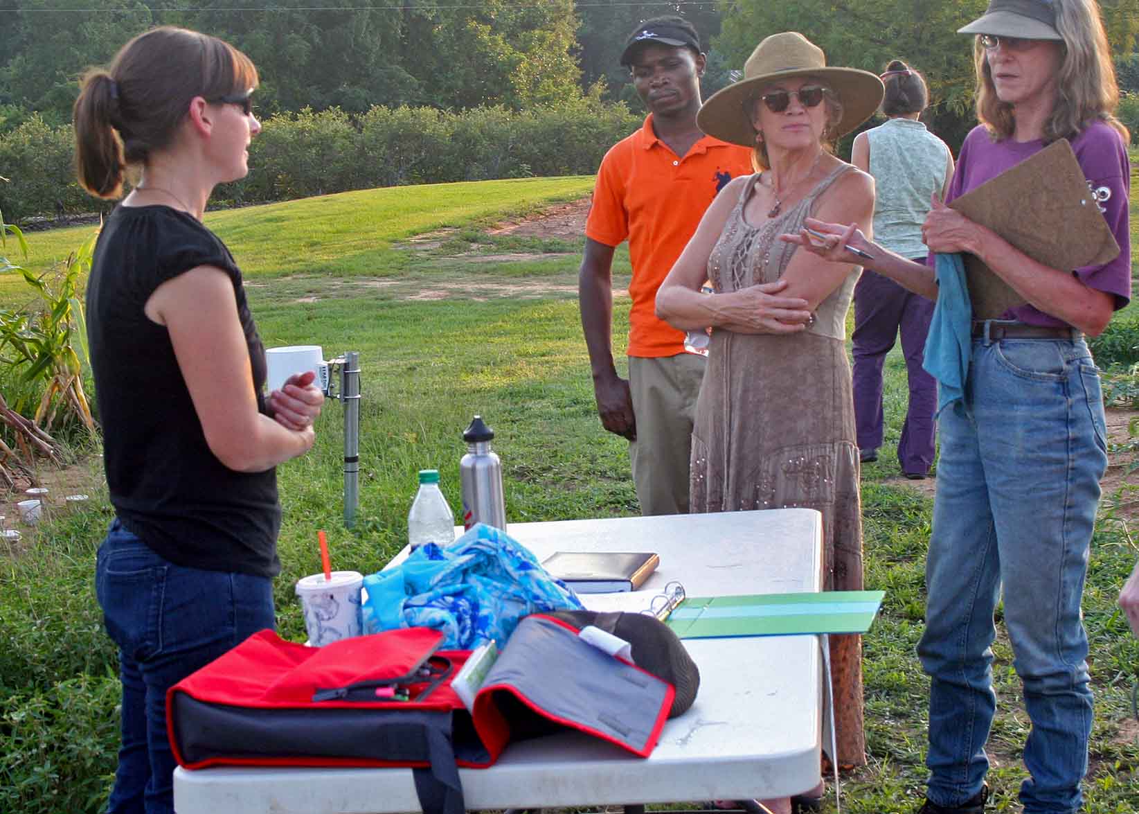 Attendees discuss growing practices at the University of Georgia's organic research farm in Watkinsville during the 2012 Organic Twilight Tour.