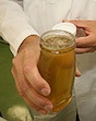 Putnam County Extension Coordinator Keith Fielder inspects a jar of honey. A Georgia Master Beekeeper, Fielder will lead a basic beekeeping class Aug. 7 in Madison.