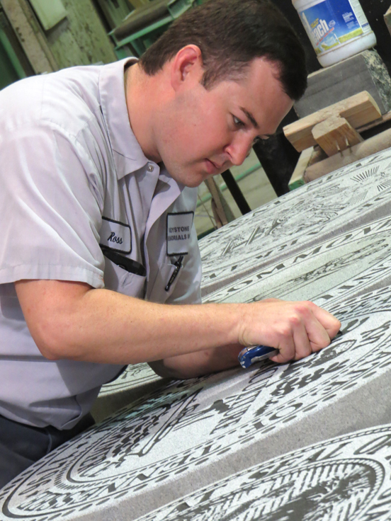 Ross Oglesby works on a seal for the Sunbelt Expo Spotlight State Building.