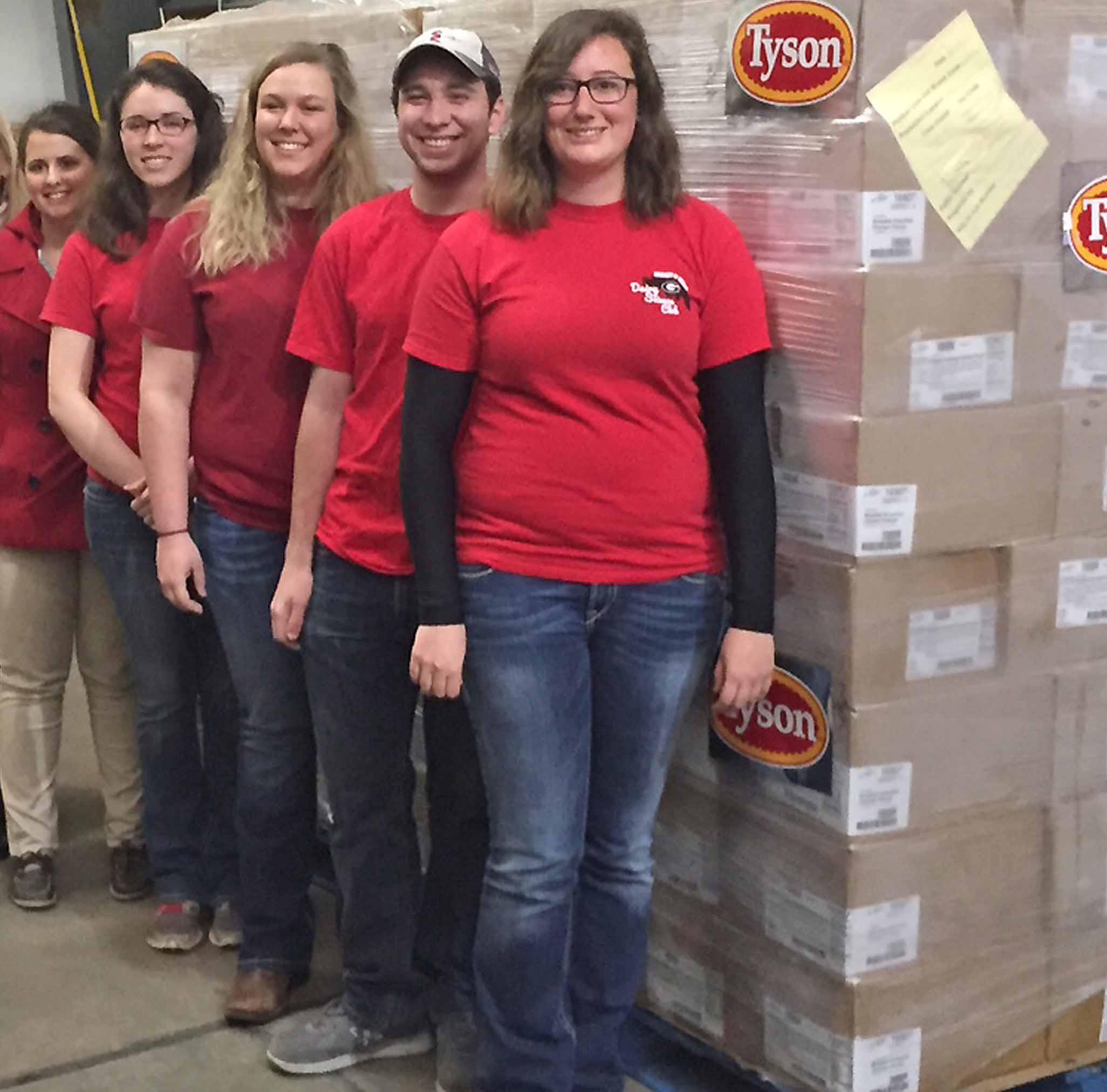 Animal Agriculture Alliance President Kay Johnson Smith and Chairman Paul Pressley work with members of the UGA Dairy Science Club, from left, Madison Rose, Hayleigh Boyd, Joseph Seta and Lark Widener, to deliver 30,400 pounds of chicken to the Food Bank of Northeast Georgia. The chicken was provided by Tyson Foods as part of a national food drive contest.