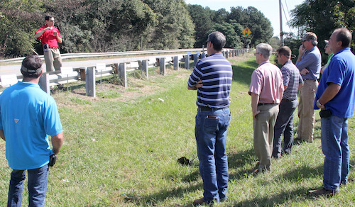 University of Georgia weed scientist Patrick McCullough shows Georgia DOT representatives weed control tests conducted by a guardrail in Griffin, Georgia. A new mobile app developed by McCullough is now being used by DOT workers who control weeds that, left unmanaged, could obstruct drivers vision.