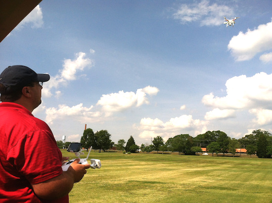 University of Georgia research technician Clay Bennett “pilots” an aerial drone over turfgrass research plots on the UGA campus in Griffin, Georgia. UGA Extension turfgrass specialist Clint Waltz uses the drone to reduce the amount of time he and Bennett spend documenting data in fields. They also use the drone to gather supplemental data through bird's-eye-view photographs of research plots.