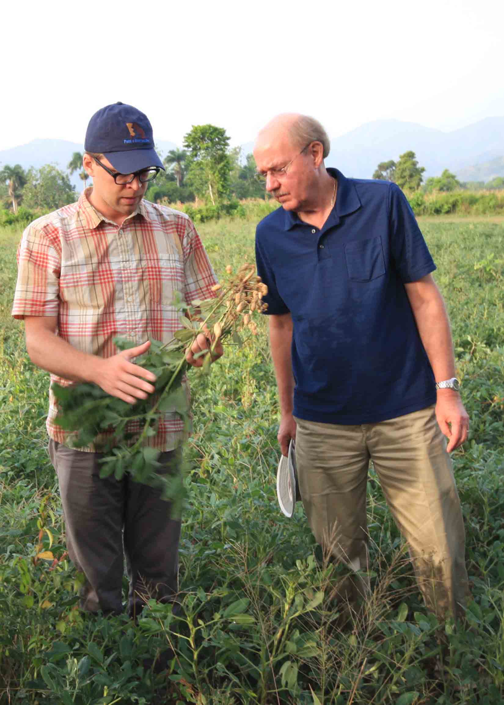 PMIL Assistant Director Jamie Rhoads and Director Dave Hoisington inspect peanuts during a 2014 trip to Haiti.