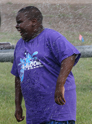 Jimmie Humphries, a Terrell County 4-H'er, gets cooled off under an irrigation pivot during a previous 4-H20 camp.