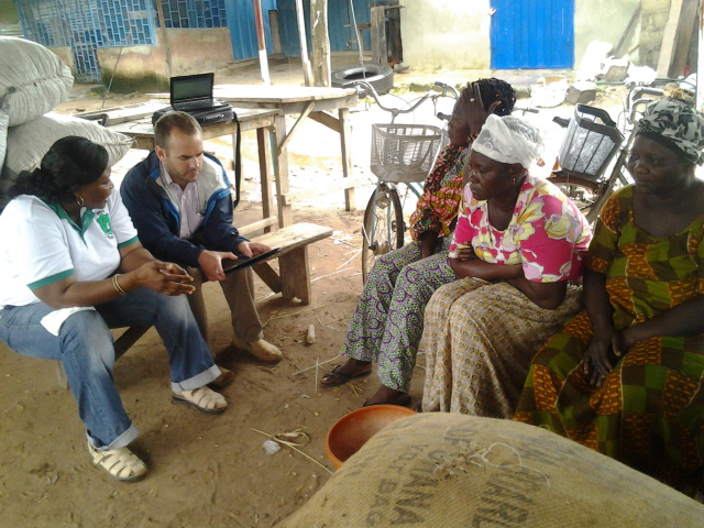 UGA agricultural economist Nick Magnan and his colleague Grace Motey interview women who work buying and selling peanuts at a market in Ghana.
