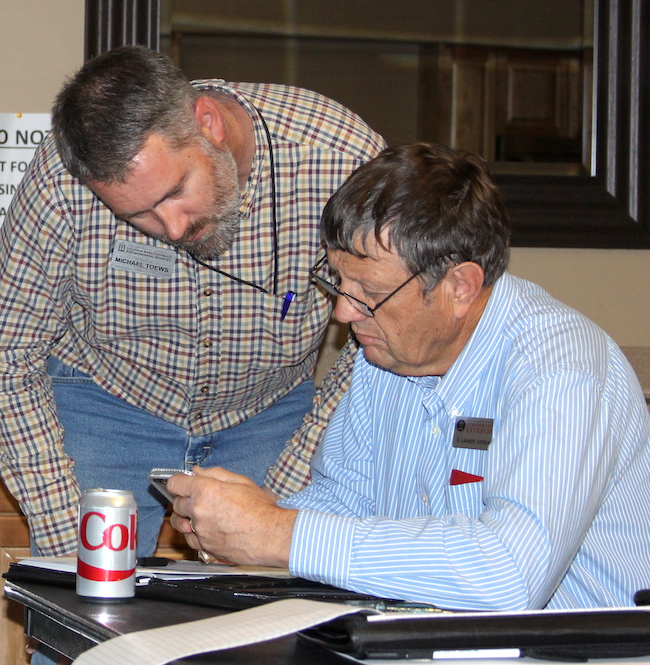 Farmers can get easy access to the latest research-based agriculture advice through a number of mobile apps available from the University of Georgia and other land-grant universities. UGA entomologist Michael Toews helps create these apps and holds workshops to share them with Georgia county agents and growers. Toews is shown (standing) sharing a mobile app with UGA Extension agent Lanier Jordan.