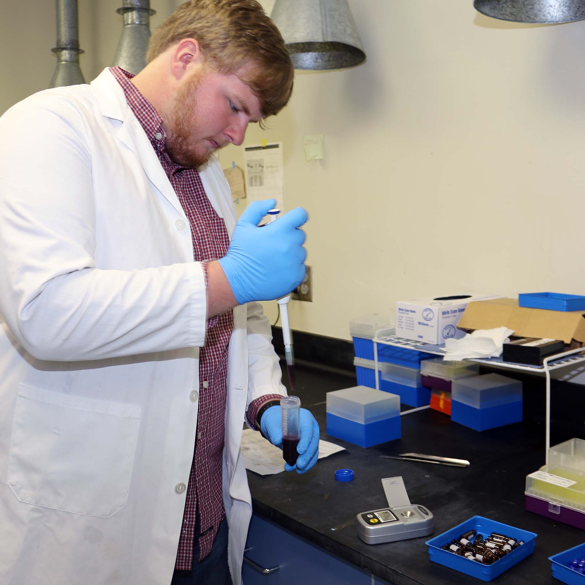UGA Cooperative Extension Agricultural and Environmental Services Laboratories lab technician Caleb Stephenson compares prepares grape juice samples for testing as part of the lab's wine grape testing program.