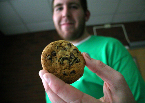 A UGA student shows off his mealworm chocolate chip cookie at the UGA Insect Zoo in April 2010.