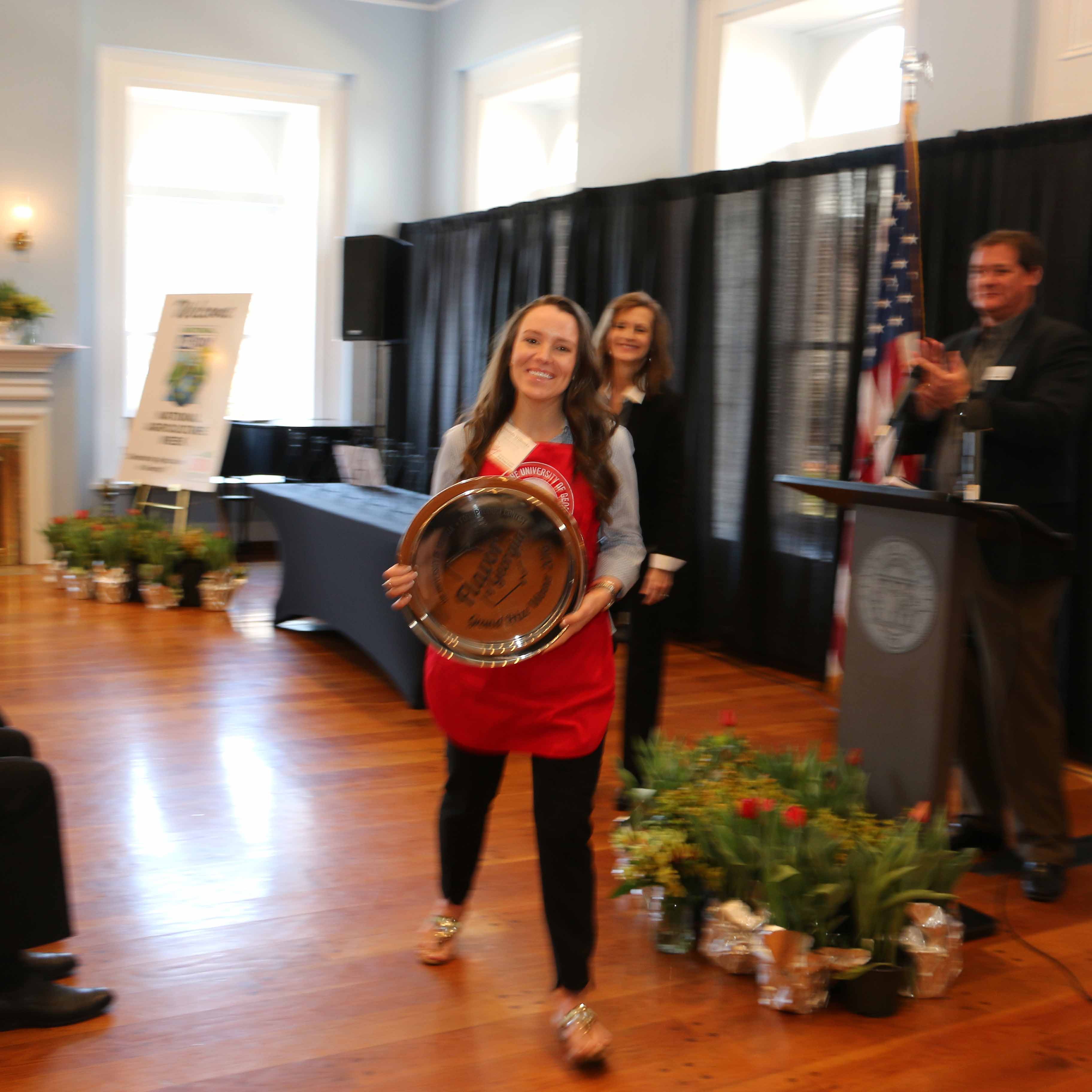 Amanda Wilbanks, owner of Southern Baked Pie Company in Gainesville, accepts her University of Georgia Flavor of Georgia grand prize trophy from Gov. Nathan Deal, UGA College of Agricultural and and Environmental Sciences Dean Sam Pardue and Georgia Agriculture Commissioner Gary Black Tuesday March 15.
