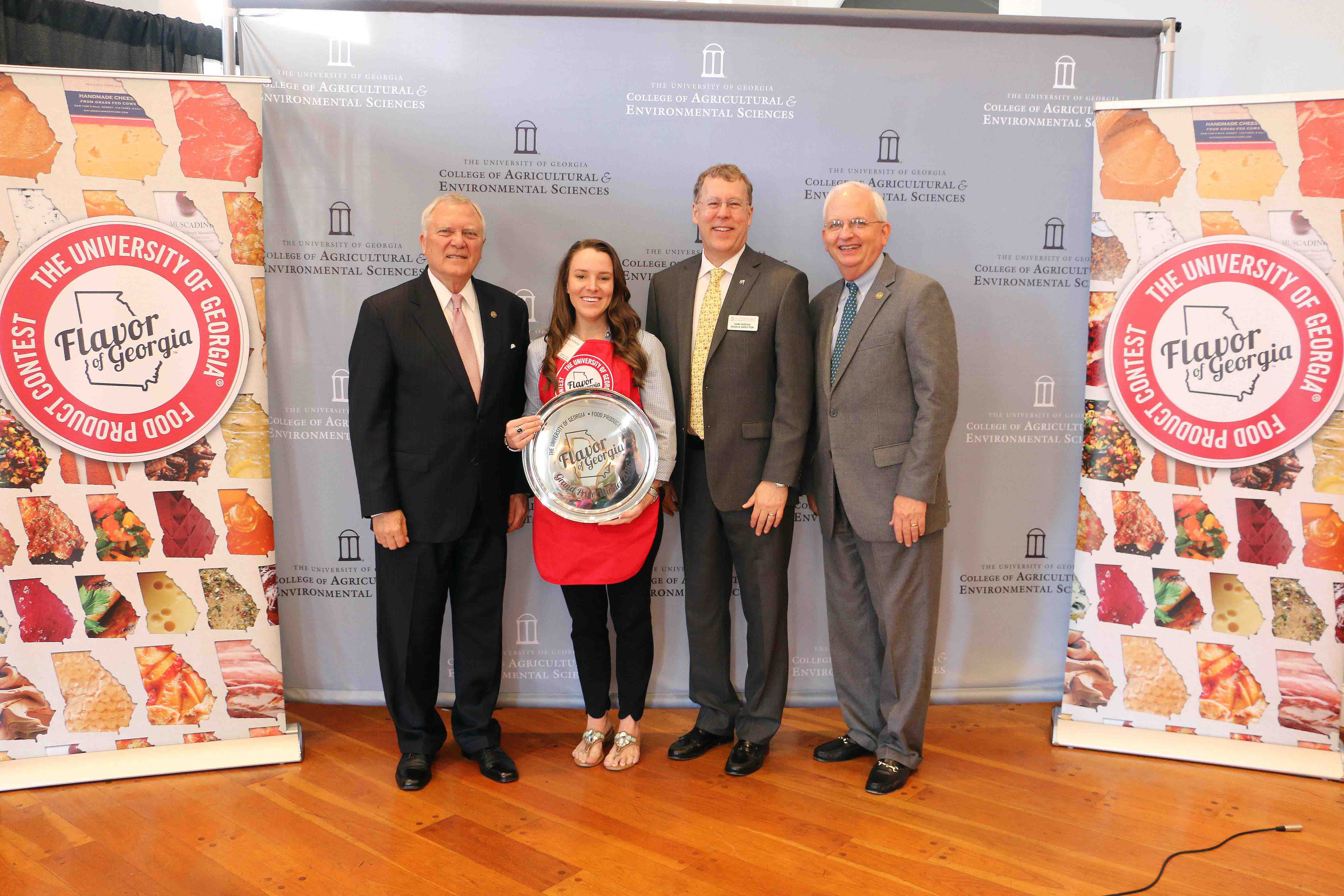 Amanda Wilbanks, owner of Southern Baked Pie Company in Gainesville, accepts her University of Georgia Flavor of Georgia grand prize trophy from Gov. Nathan Deal, UGA College of Agricultural and and Environmental Sciences Dean Sam Pardue and Georgia Agriculture Commissioner Gary Black Tuesday March 15.