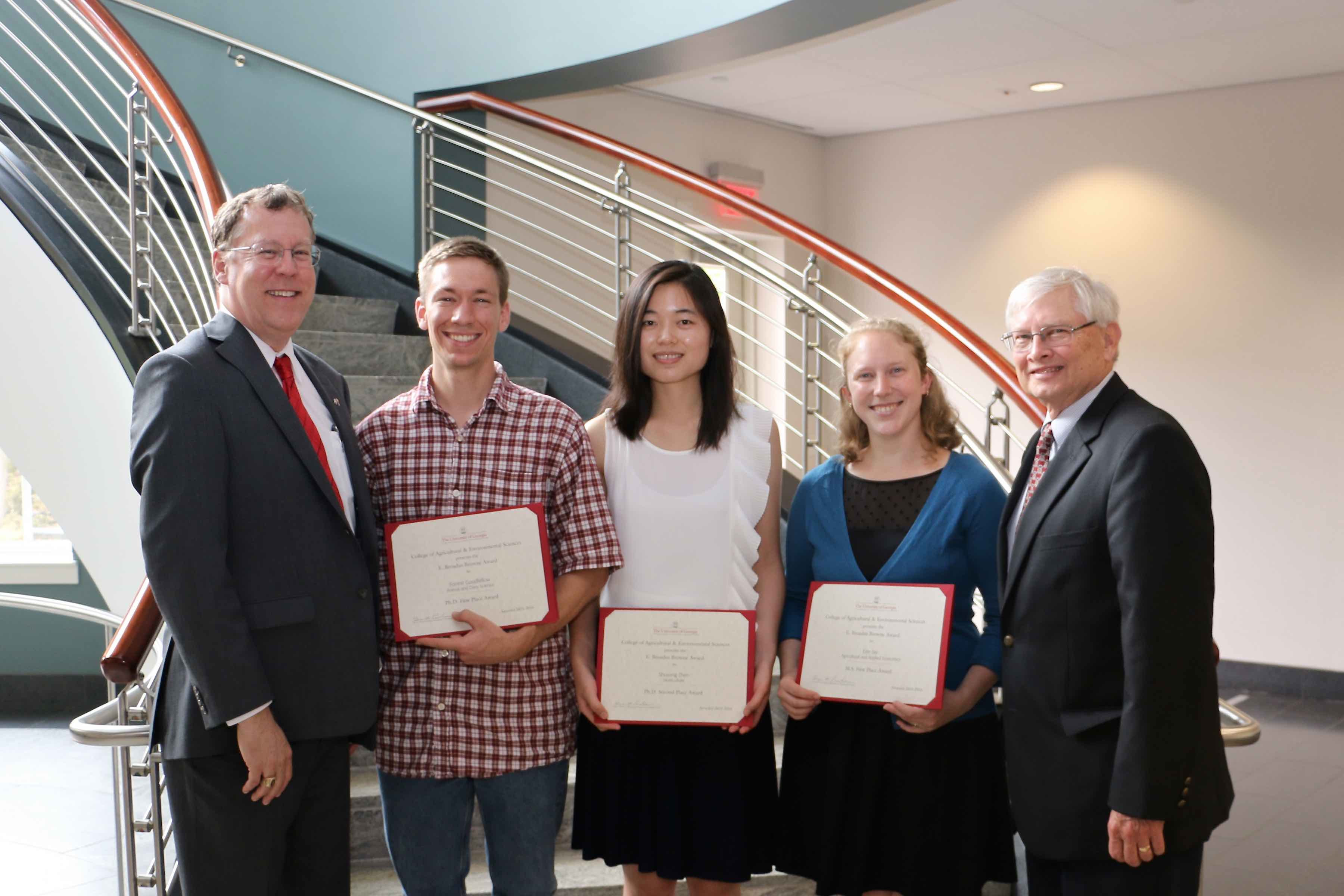 UGA College of Agricultural and Environmental Sciences Dean and Director Sam Pardue, far left, and CAES Associate Dean for Research Bob Shulstad, far right, congratulate doctorate students Forrest Goodfellow and Shuyang Zhen and master's degree student Erin Roestshcehl on their E. Broadus Browne Awards for creative research.