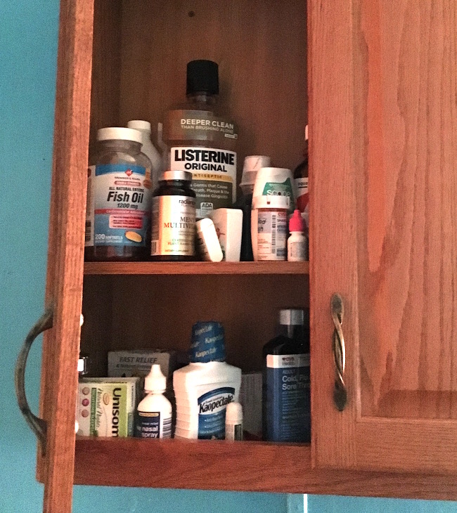 A medicine cabinet filled with medicine and personal hygiene items.