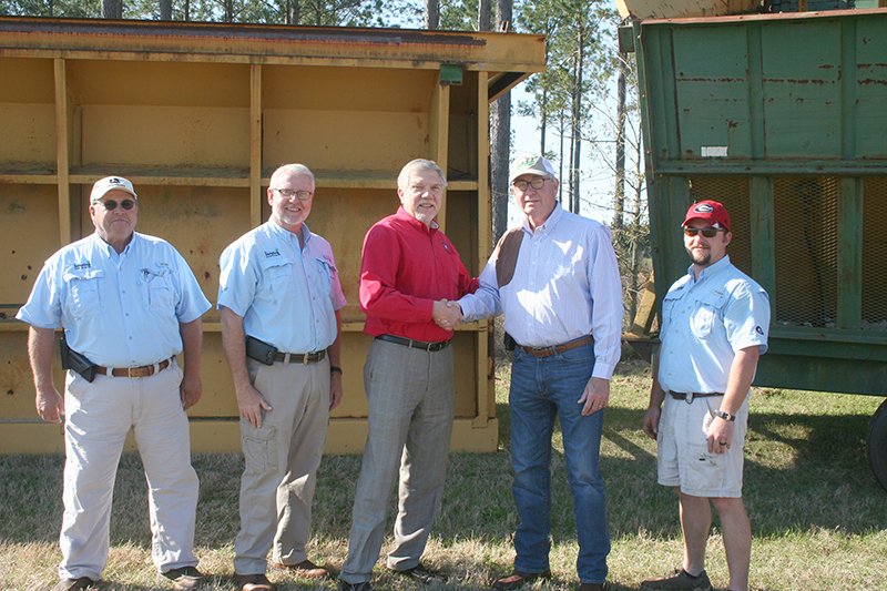 Joe West (third from left), assistant dean of the UGA Tifton Campus, shakes hands with Tom Stallings, owner of Funston Gin in Funston, Georgia. Stallings donated cotton-harvesting equipment to UGA's C.M. Stripling Irrigation Research Park (SIRP), which West oversees. Also pictured are SIRP employees (left to right) Ivey Griner, Superintendent Calvin Perry and B.J. Washington.
