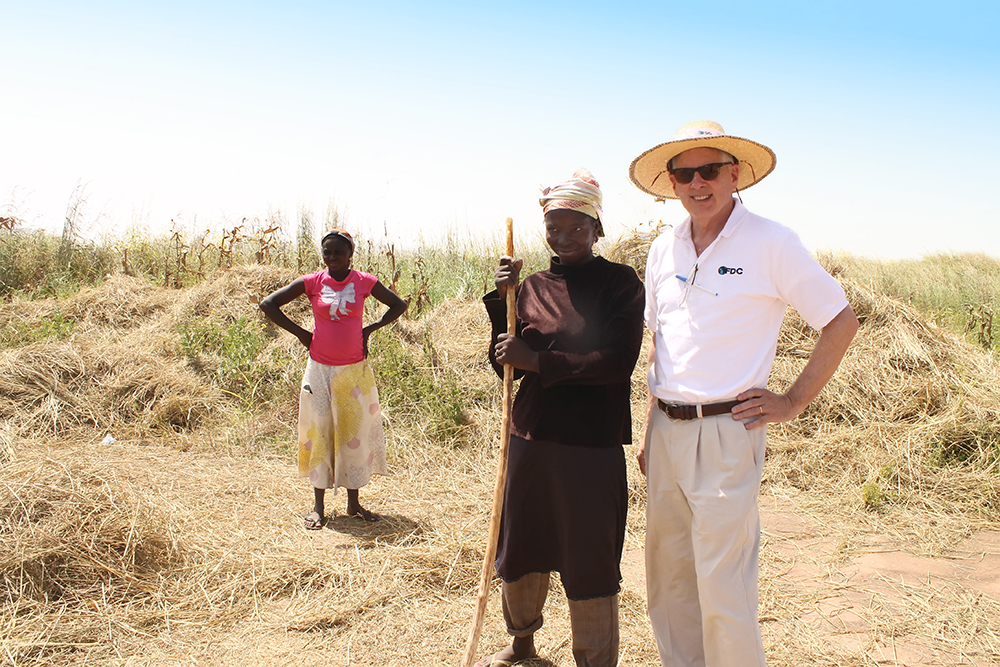Former UGA CAES dean and director Scott Angle, pictured in hat, took a job with the International Fertilizer Development Center in 2015. After a decade of leading CAES's research, outreach and teaching efforts, he now spends his days working to help farmers in developing nations. This photo was taken on a trip to Ghana, where women are responsible for more than 40 percent of agricultural activities.