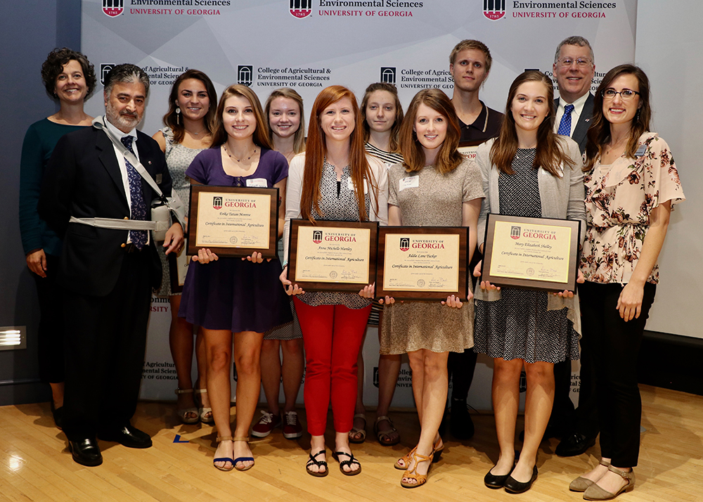 The UGA CAES Office of Global Programs recognized eight students for completing the college's Certificate in International Agriculture. From left, Assistant Director of the Office of Global Programs Vicki McMacken, and Director of the Office of Global Programs Amrit Bart, congratulate Carleen Porter, Tatum Monroe, Sarah Pate, Anna Hartley, Anna Trakhman, Addie Tucker, Aiden Holley and Mary Shelley with CAES Dean Sam Pardue and CAES Director of Experiential Learning Amanda Stephens.