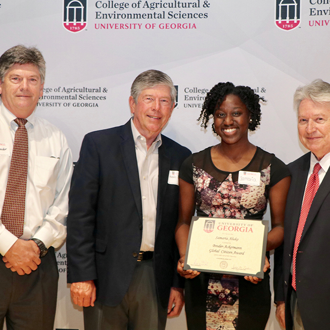 Patrick Broder and Hans Broder Jr., left, and Josef Broder, far right, congratulate Samaria Aluko, the inaugural winner of the Broder-Ackermann Global Citizen Award, on April 18 at CAES's seventh annual International Agriculture Day reception. Aluko will receive a $1,000 scholarship to support her work helping to provide health care to underserved communities.