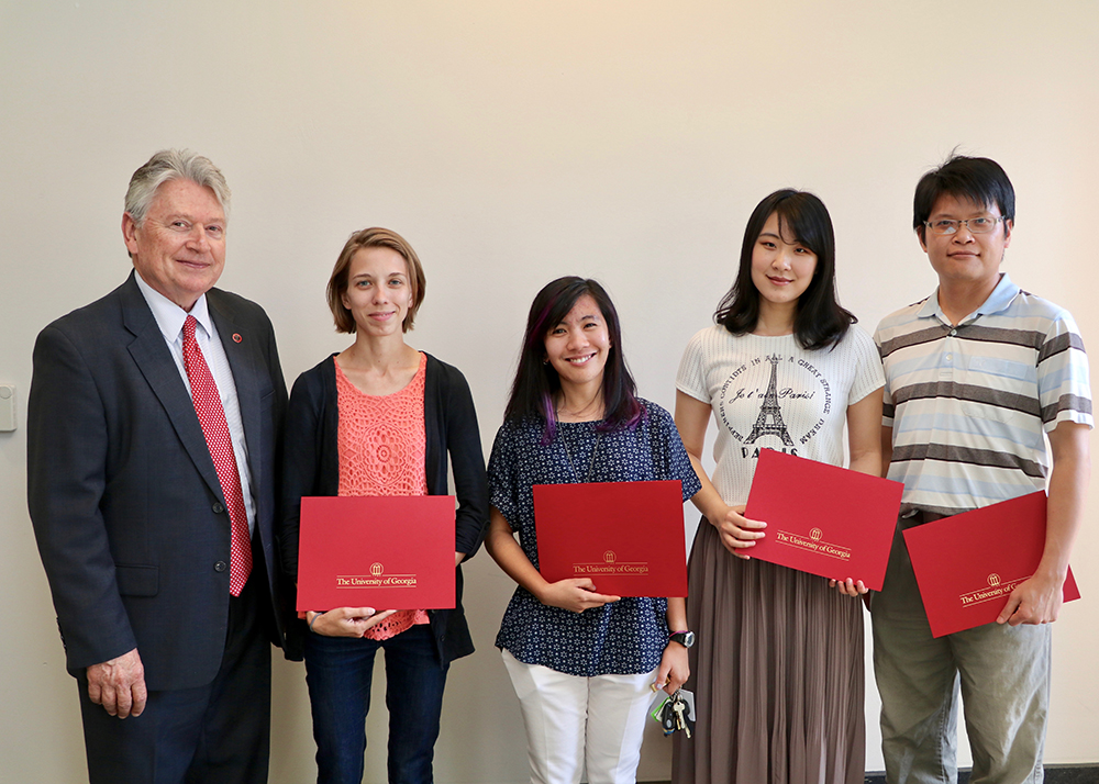 CAES Associate Dean for Academic Affairs Josef Broder congratulates CAES graduate students, from left, Ashley Duxbury, Leilani Sumabat, Shan Gao and Cheng-Fang Hong for winning CAES 2017 Outstanding Teaching Awards. The awards recognize graduate students who have achieved excellence in the classroom.