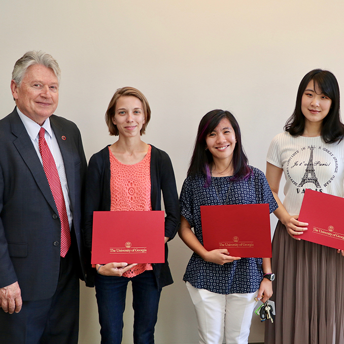 CAES Associate Dean for Academic Affairs Josef Broder congratulates CAES graduate students, from left, Ashley Duxbury, Leilani Sumabat, Shan Gao and Cheng-Fang Hong for winning CAES 2017 Outstanding Teaching Awards. The awards recognize graduate students who have achieved excellence in the classroom.