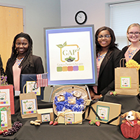 Chatham County 4-H Club members, from left, Sonté Davis, Faythe Robinson, Ashley Johnson, Anna Morris and Amari McDonald pose with the display for their award-winning GAP2 concept for locally sourced baked goods.