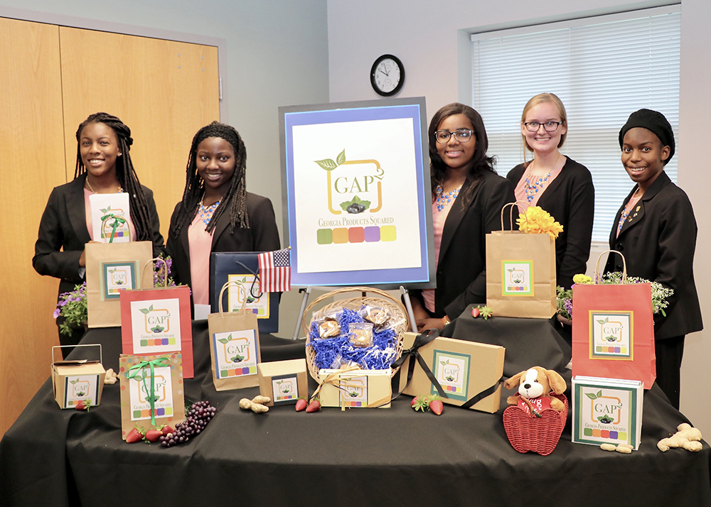Chatham County 4-H Club members, from left, Sonté Davis, Faythe Robinson, Ashley Johnson, Anna Morris and Amari McDonald pose with the display for their award-winning GAP2 concept for locally sourced baked goods.