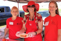 Spalding County Family and Consumer Sciences Agent Cindee Sweda (center) serves up tomato sandwiches at Mater Day with the help of University of Georgia Master Gardener Extension Volunteers Kristeen Harrison (left) and Trisha Walker (right).