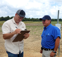 New UGA Extension water educators John Loughridge (left) and Luke Crosson (right) collect center pivot information from a landowner, David Burk (middle).