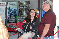 University of Georgia College of Agricultural and Environmental Sciences student Mollie Cromley talks with a visitor to the college's building at the 2017 Sunbelt Agricultural Expo in Moultrie, Georgia.