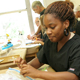 High school students practice their suturing skills.