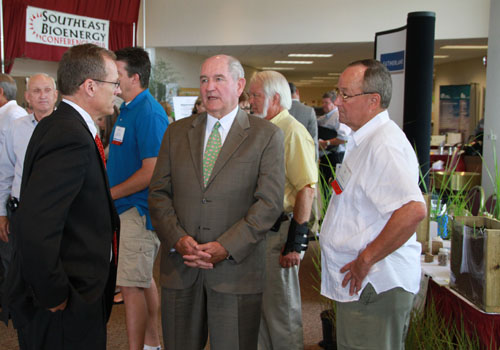 Georgia Gov. Sonny Perdue is shown (center) visiting with U.S. Rep. Jack Kingston (left) and Bill Brim (right) of Lewis Taylor Farms during the 2010 Southeast Bioenergy Conference.