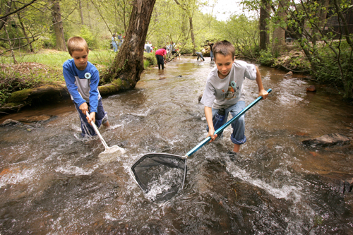 Alpharetta Elementary 4th graders from left Joey Santoro, 10, and Neal Seaman, 10, search a stream for life during environmental education at Washega 4H camp in Dahlonega, Thursday, April 28, 2005.