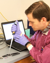 University of Georgia Research Professional David Mann works on a portable sequencer in food scientist Xiangyu Deng's laboratory in the UGA Center for Food Safety in Griffin, Georgia. Deng has developed a one-step method of detecting and subtyping food pathogens called “metagenomics analysis.” The method is much quicker than traditional methods, and time is essential during outbreaks of foodborne illness.