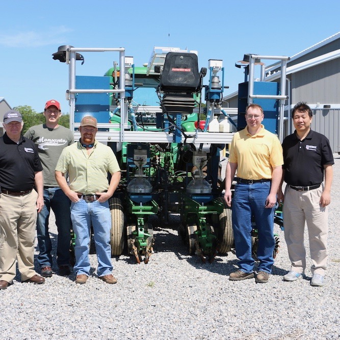 Crop and soil science research coordinator Dale Wood, from left, doctoral student Ben Stewart-Brown, research professional Brice Wilson, Monsanto fleet manager Brian Brand and Professor Zenglu Li stand with a new Alamco planter.
