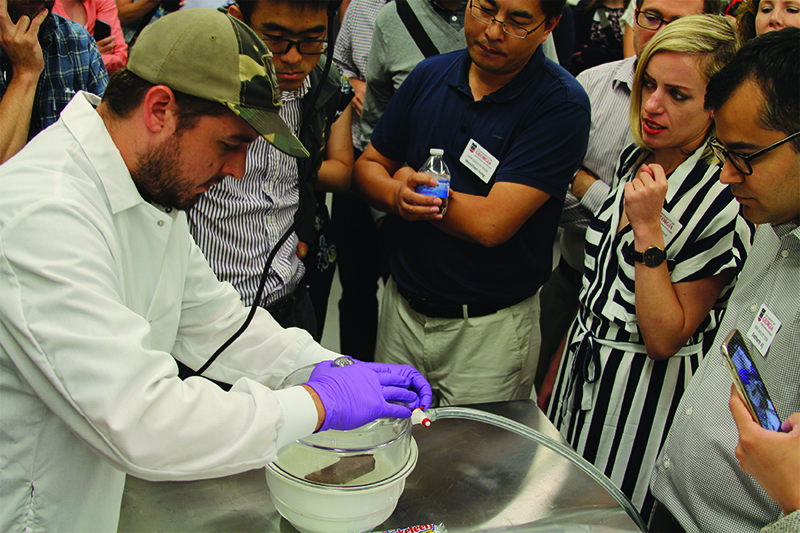 Bobby Goss, a FoodPIC research technician, tells the faculty about UGA chocolate research.