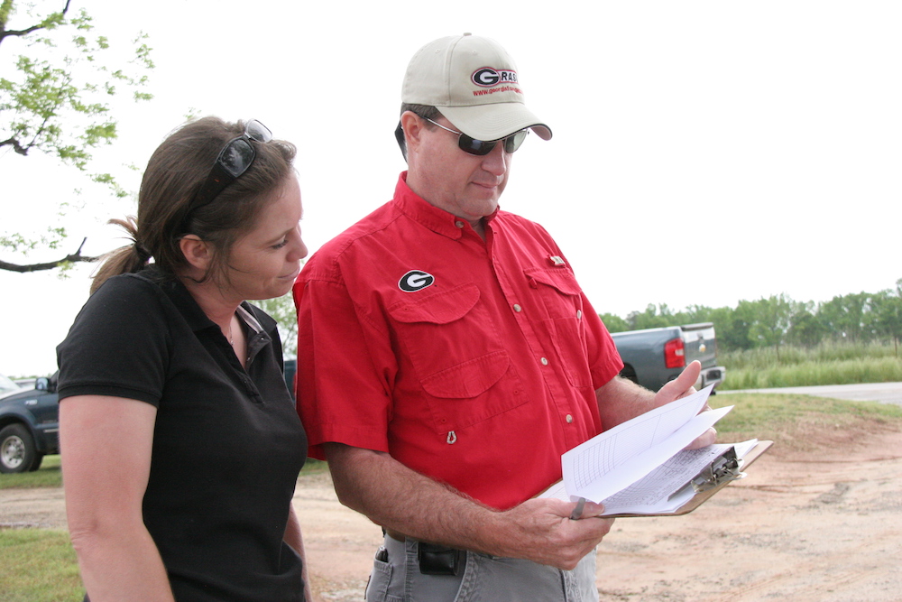 Bobby Smith, newly appointed district director for UGA Cooperative Extension's Northeast Georgia district, reviews the schedule at a field day in Morgan County with current Morgan County Extension Coordinator Lucy Ray.