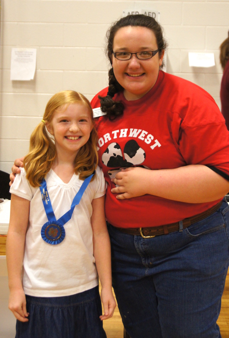 A Fayette County 4-H'er celebrates with her agent after winning a Georgia 4-H Project Achievement competition.