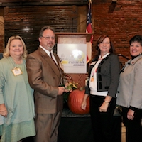 Tammy Cheely, University of Georgia Cooperative Extension county coordinator for Warren County; Scott Richardson, technical education and nutrition director for Warren County Schools; Becky Griffin, UGA Extension community and school garden coordinator and Laura Perry Johnson, associate dean and director of UGA Extension celebrate the presentation of UGA Extensions inaugural Golden Radish Outstanding Extension Farm to School Program Award.