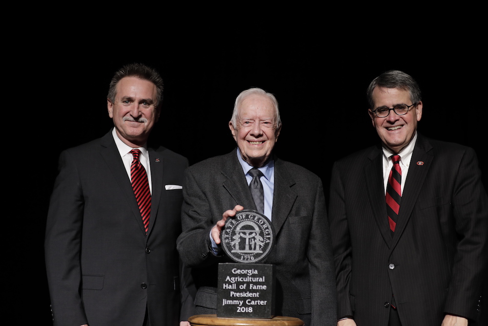 University of Georgia College of Agricultural and Environmental Sciences Alumni Association President Van McCall, left, and University of Georgia President Jere Morehead congratulate former President of the United States Jimmy Carter after his induction into the Georgia Agricultural Hall of Fame November 9 at UGA.