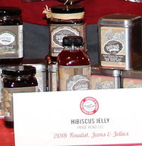 Pride Road's hibiscus jelly was a finalist in Flavor of Georgia's 2018 Jams and Jellies category. The University of Georgia's Food Product Innovation and Commercialization (FoodPIC) Center in Griffin, Georgia, helped the Smyrna, Georgia, company dry the fresh flowers and then make them into a range of hibiscus products: jelly, jam, tea and chutney. Pride Road's owners (center) are shown at the 2018 Flavor of Georgia contest with members of the FoodPIC staff.