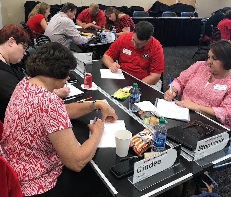 Participants in Extension Academy are shown writing their personal goal statements for their growth plan. UGA Cooperative Extension Agent Clark MacAllister said the program made him look inside himself and examine his own personality and how he is perceived by others.