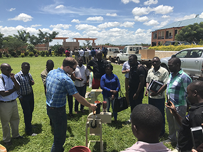 Peanut Innovation Lab Assistant Director Jamie Rhoads demonstrates a small-scale sheller in Malawi in March 2019 while working with the Malawi Agricultural Diversification Activity. Photo by Dave Hoisington