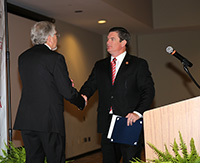 UGA-Tifton Assistant Dean Joe West shakes hands with Congressman Austin Scott (GA-08) as he gets ready to speak during the centennial celebration.